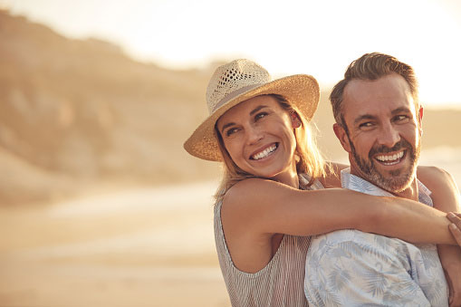 Couple smiles at the beach