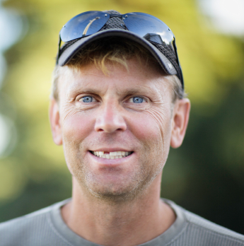 Smiling man with a missing tooth.