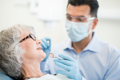 Woman getting a dental exam at Brush & Floss Dental Center in Stratford, CT